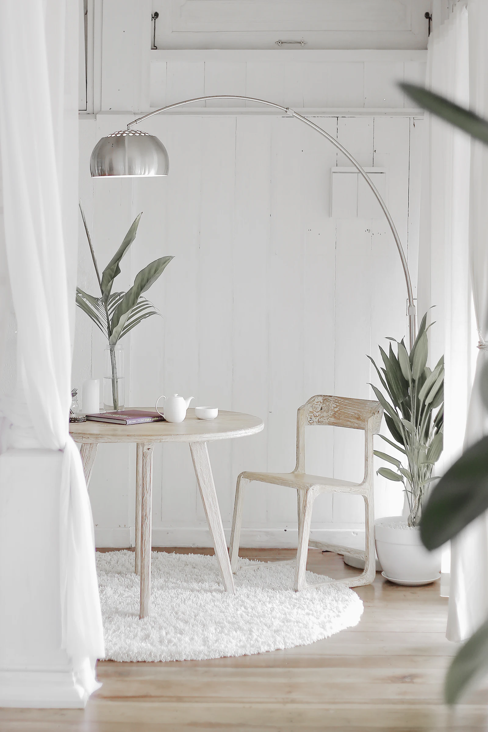 A calm, light-filled interior with plants and simple furnishings. Illustrative photography.